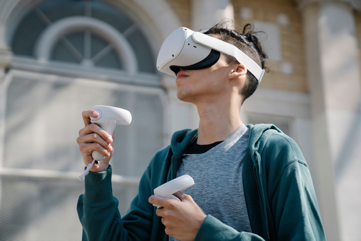 Male experiencing virtual reality headset on street